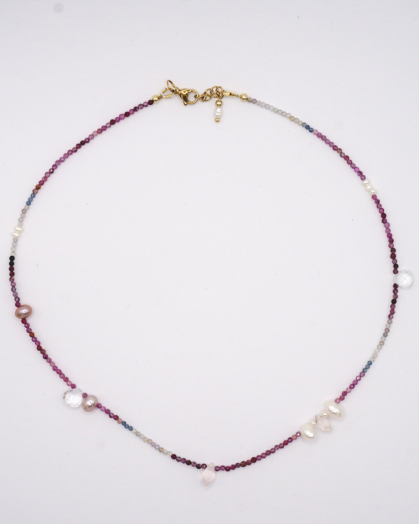 Colorful spinel gemstone necklace with topaz, rose quartz, and freshwater pearl droplets in between.
A specially designed piece that is unique and dainty while being colorful and eclectic.